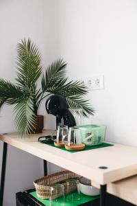 a table with a coffee maker and a plant on it at La Parcela in Peñíscola +34 photos
