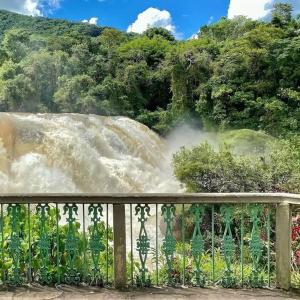 a view of a waterfall from a fence at Living in Poços de Caldas +19 photos