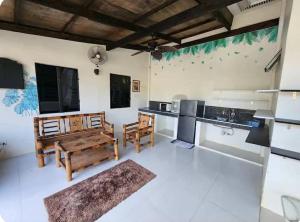 a large kitchen with a table and chairs in it at JMC7 Furnished Villa Near Panglao Airport in Panglao +10 photos