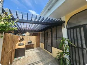 a pergola on the side of a house at JMC7 Furnished Villa Near Panglao Airport in Panglao