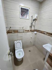 a bathroom with a toilet and a sink at JMC7 Furnished Villa Near Panglao Airport in Panglao