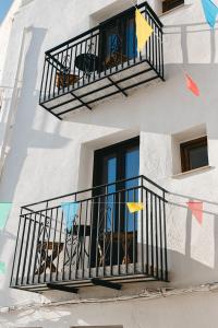 un edificio bianco con un balcone con bandiere di La Parcela a Peñíscola