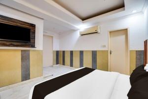 Ένα ή περισσότερα κρεβάτια σε δωμάτιο στο Hotel O HAPPY STAY INN