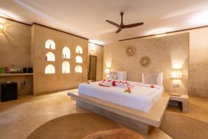 a bedroom with a large white bed in a room at Safaya Luxury Villas - Adults only in Nungwi