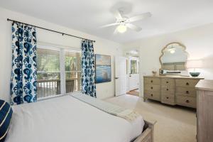 a bedroom with a bed and a dresser and a window at SM14: 14 Silver Moss in Kiawah Island +55 photos