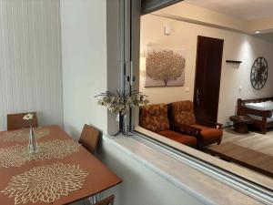 a dining room with a table and a chair and a mirror at Chios Orange Tree Retreat in Chios
