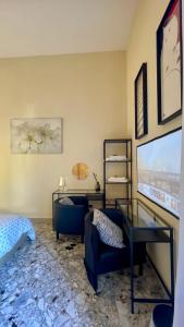 a living room with a glass table and a chair at Three Rooms in Messina
