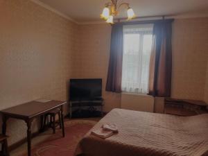 a bedroom with a bed and a television and a table at Felicità Family Club  +19 photos