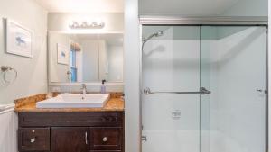 a bathroom with a sink and a shower at Coastal Bayside Condo Walkable to Sand Surf in Newport Beach +20 photos