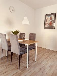 a dining room table with two chairs and a table with wine glasses at Haus Nordwind in Wilhelmshaven +4 photos