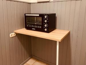 a microwave oven sitting on a shelf on a wall at Haus Nordwind in Wilhelmshaven