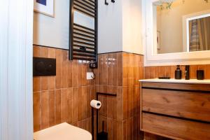 a bathroom with a sink and a toilet and a mirror at Maison Luxury Plaza in Rome