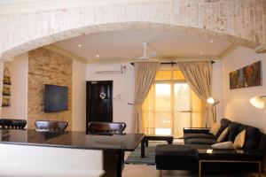 a living room with a couch and a table at Manaya Luxury Sunset & Serenity Serviced 2Bedroom by Diani Beach with Pool & Parking in Galu