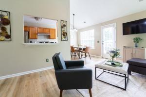 a living room with a couch and a table at Family & Couples Getaway Near Lake Norman Firepit King Suite in Troutman