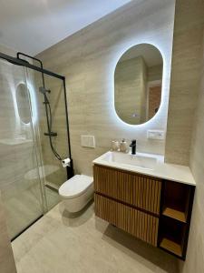 a bathroom with a toilet and a sink and a mirror at Picasso 2 Royale in Marbella +13 photos