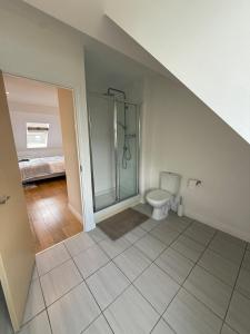 a bathroom with a shower and a toilet at Elegant Home in West Didsbury in Manchester
