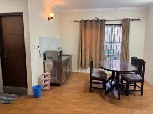 a dining room with a table and a microwave at My Stay Nepal in Kathmandu