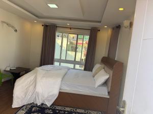 a small bedroom with a bed with a window at My Stay Nepal in Kathmandu