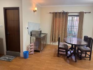 a dining room with a table and a microwave at My Stay Nepal in Kathmandu +8 photos
