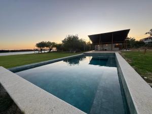a swimming pool in front of a building at Casa Aloha in Petrolina