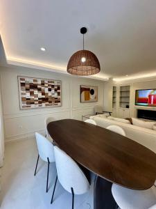 a dining room with a table and chairs and a couch at Picasso 2 Royale in Marbella