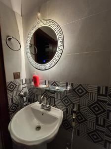 a bathroom with a sink and a mirror at The little nest in Islamabad