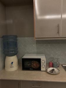 a kitchen counter with a blender and a toaster oven at The little nest in Islamabad