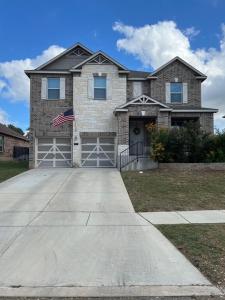 a brick house with an american flag in the driveway at Relax with Spacious Modern Simplicity in Boerne
