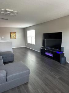 a living room with a couch and a flat screen tv at Relax with Spacious Modern Simplicity in Boerne