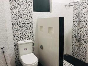a bathroom with a toilet and a shower at Jungle view one bedroom apartment in Unawatuna
