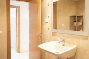 a bathroom with a sink and a mirror at NT Bright and modern apartment in Pizarra in Pizarra