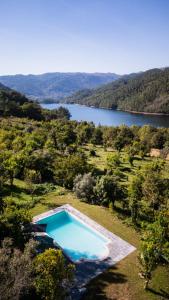 LouredoにあるQuinta do Assentoの湖のある野原にあるプールの上空からの眺め