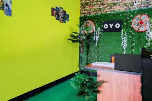 a restaurant with a neon green wall and a counter at SPOT ON S.D.S GUEST HOUSE in Guwahati