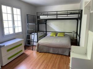 a bedroom with a bunk bed with two yellow pillows at Chambres dans maison avec piscine toboggan aquatique et spa in Saint-Mars-la-Brière