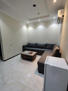 a living room with a couch and a coffee table at AL Tamayoz Alraqi - Hira branch in Jeddah