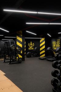 a gym with dumbbells and weights in a room at The Nest Loft in Riyadh