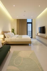 a bedroom with a bed and a flat screen tv at The Nest Loft in Riyadh +4 photos