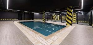 an empty swimming pool in a building with at The Nest Loft in Riyadh