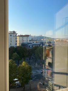 a view of a city from a window at Appartement partagé -Place Jean Mace in Lyon