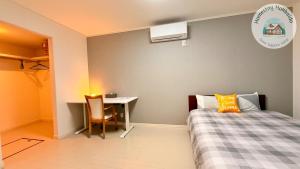 a small bedroom with a bed and a desk at Snow Sapporo cozy house in Sapporo +10 photos