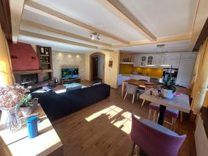 a large living room with a couch and a table at Tannenheim Lodge Flumserberg in Flumserberg