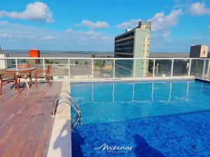 a swimming pool on the roof of a building at One Cabo Branco-Poucos Metros da Praia in Tambaú