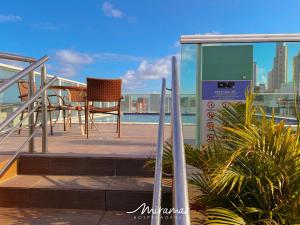 a balcony with a table and chairs on a building at One Cabo Branco-Poucos Metros da Praia in Tambaú +25 photos