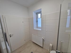 a bathroom with a toilet and a window at Mariazell Appartement Kugeltreff in Mariazell +22 photos