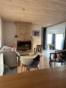 a living room with a couch and a fireplace at Charmante maison 2 Chambres à 10 mn d'Angers et 1h15 du Puy in Corné