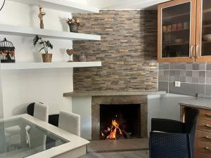 a fireplace in a living room with a fire place at A Casa da Azenha in Sertã
