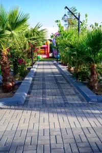 a walkway in a park with trees and plants at منتجع حياة رويال الطائف in Taif