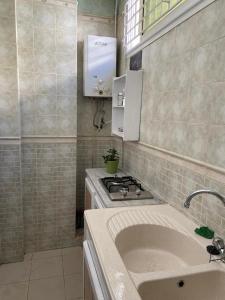 a small kitchen with a stove and a sink at Dar Saïda Guest house in Tunis +16 photos