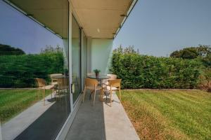 a patio with a table and chairs and a lawn at Amazing Pool Apartments by Vacationy in Vila Nova de Gaia
