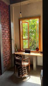 a room with a desk with a window and a chair at Sand Dollar House Hiriketiya Apartment in Dickwella +10 photos